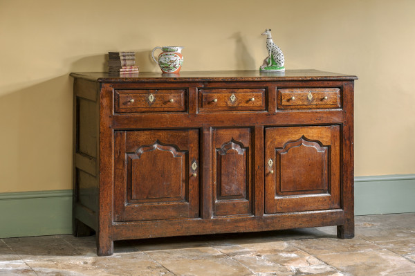 old english antique kitchen dresser base on flagstone floor